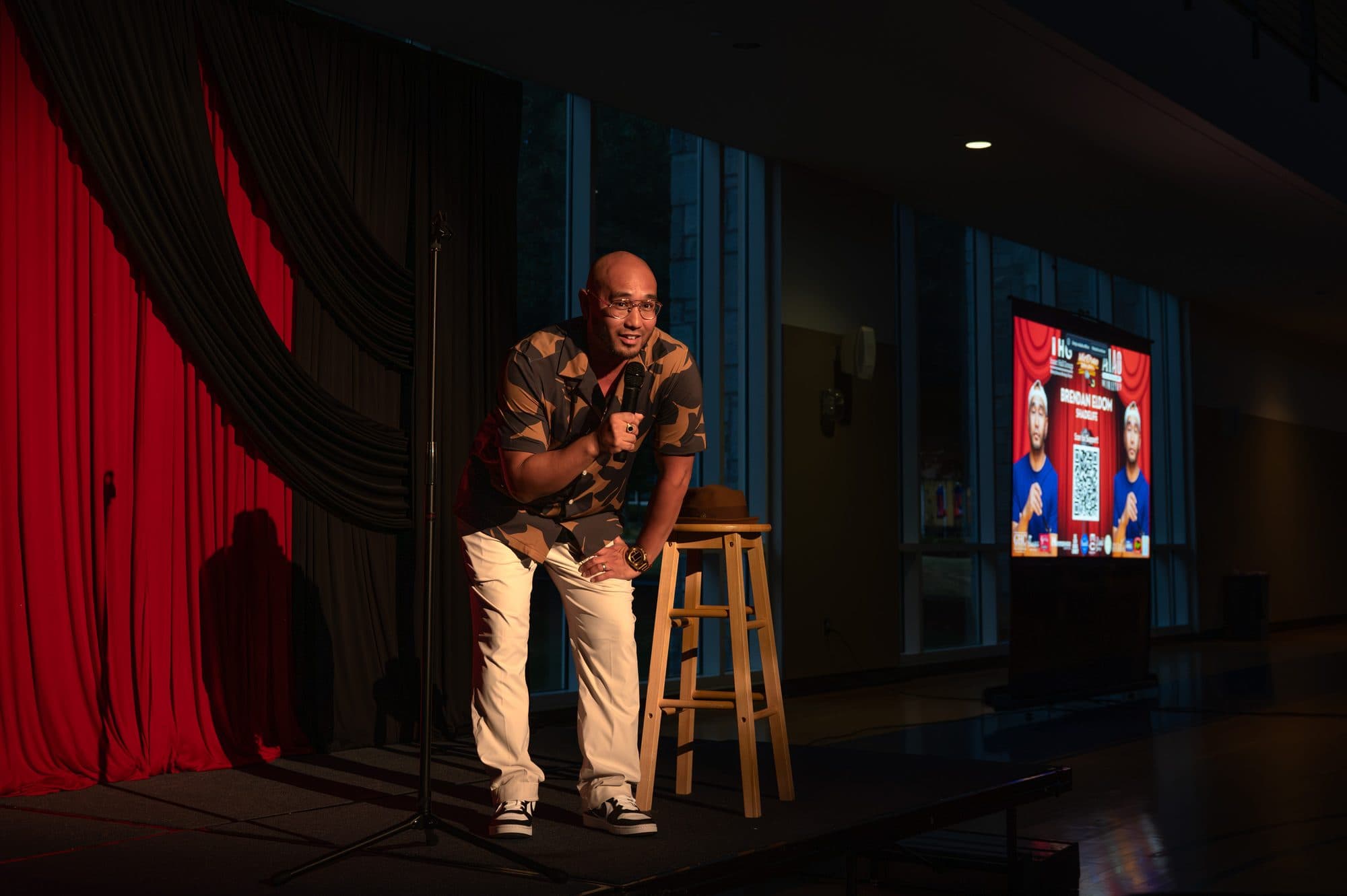 Comedian performing a stand-up set on stage at Mic Drop Masters 2026.