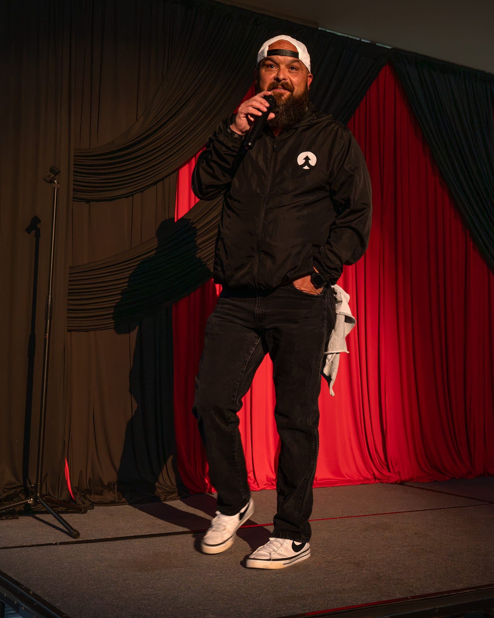 Comedian performing a stand-up set on stage at Mic Drop Masters 2026.