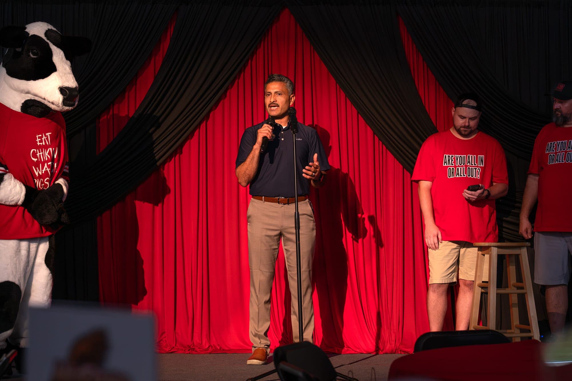 Speaker addressing the crowd at the Mic Drop Masters 2026 fundraiser.